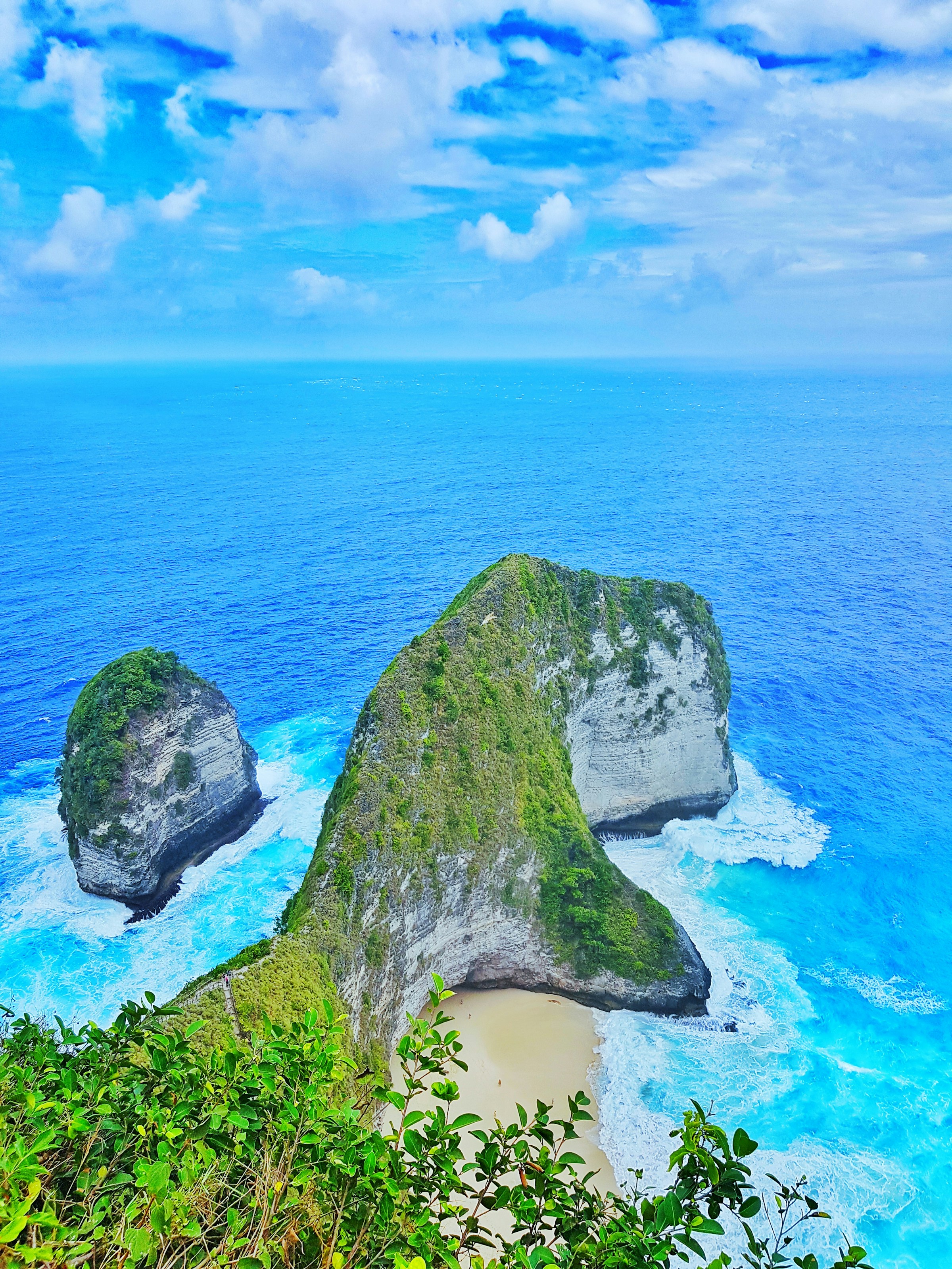A lush green headland and turquoise ocean in Bali